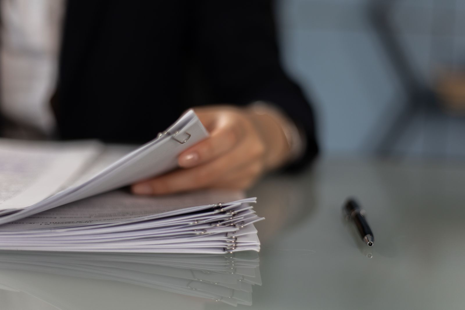 A reader paging through a stack of application files