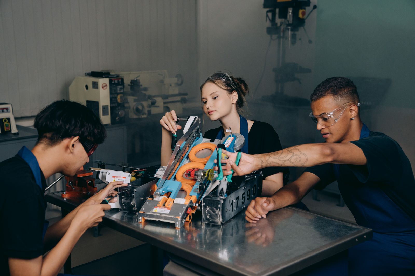 Students building a robotics project together